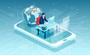 A mortgage broker sitting behind a desk using a computer on top of a cellphone with a globe behind him