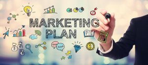Businessman drawing Marketing Plan concept on blurred abstract background