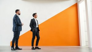 Mortgage loan officer reviewing a focused pipeline measurement discussion in a bright modern office