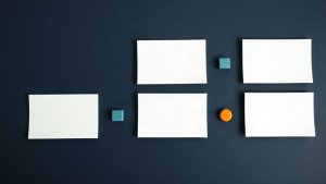 Abstract editorial illustration of blank mortgage social media planning cards with teal and orange markers on navy